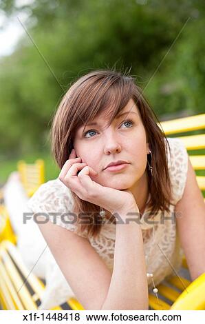 A young slim attractive girl in her late teens or early 20's thinking, looking pensive thoughtful, UK View Large Photo Image Stock Photo - A young slim attractive girl in her late teens or early 20's thinking, looking pensive thoughtful, UK. Fotosearch