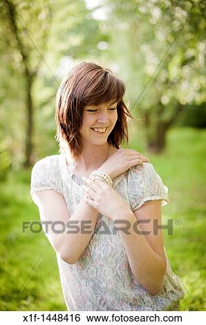 A young slim attractive girl in her late teens or early 20? s, outdoors in a woodland glade UK View Large Photo Image Stock Photograph - A young slim attractive girl in her late teens or early 20? s, outdoors in a woodland glade UK. Fotosearch