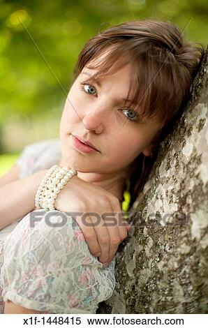 A young slim attractive girl in her late teens or early 20? s, outdoors in a woodland glade UK View Large Photo Image Stock Photography - A young slim attractive girl in her late teens or early 20? s, outdoors in a woodland glade UK. Fotosearch