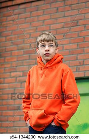 A young teen boy standing outdoors View Large Photo Image Stock Image - A young teen boy standing outdoors. Fotosearch