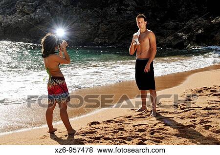 A young teenage girl photographing a model on the beach View Large Photo Image Stock Photo - A young teenage girl photographing a model on the beach. Fotosearch
