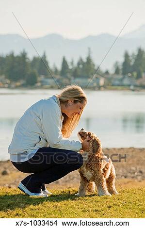 A young woman and her dog at the lake View Large Photo Image Picture - A young woman and her dog at the lake. Fotosearch