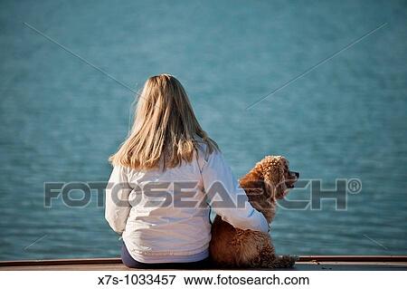 A young woman and her dog at the lake View Large Photo Image Stock Photo - A young woman and her dog at the lake. Fotosearch