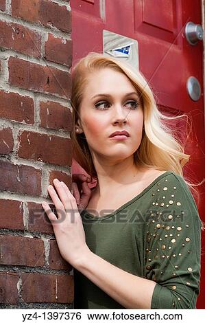 A young woman by a building View Large Photo Image Stock Photograph - A young woman by a building. Fotosearch