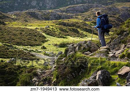 A young woman carrying a large backpack near the summit of Haystacks in the Lake District. View Large Photo Image Stock Image - A young woman carrying a large backpack near the summit of Haystacks in the Lake District.. Fotosearch