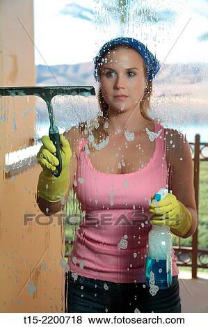 A young woman cleaning the window. View Large Photo Image Stock Photo - A young woman cleaning the window.. Fotosearch