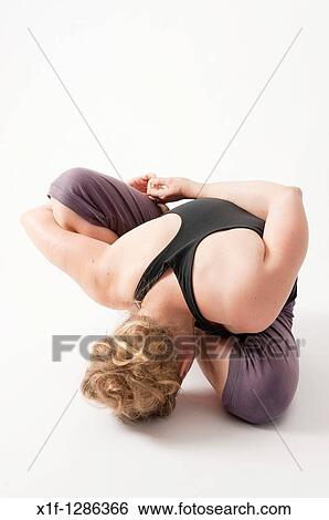 A young woman doing yoga View Large Photo Image Stock Photograph - A young woman doing yoga. Fotosearch