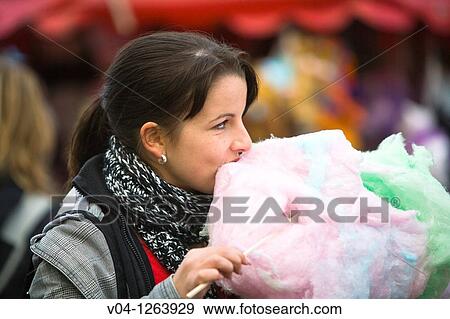 A young woman eating cotton candy at the Bremen Annual Fair, Bremen, Germany, Europe View Large Photo Image Stock Photo - A young woman eating cotton candy at the Bremen Annual Fair, Bremen, Germany, Europe. Fotosearch