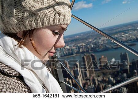 A young woman enjoys the view from the Empire State Building, New York, NY, USA View Large Photo Image Stock Image - A young woman enjoys the view from the Empire State Building, New York, NY, USA. Fotosearch