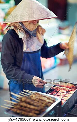 A young woman grilling chicken satay on the street View Large Photo Image Stock Photo - A young woman grilling chicken satay on the street. Fotosearch