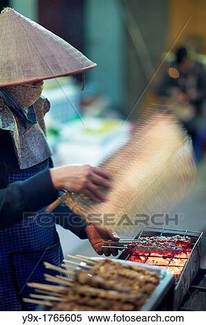 A young woman grilling chicken satay on the street View Large Photo Image Stock Photography - A young woman grilling chicken satay on the street. Fotosearch