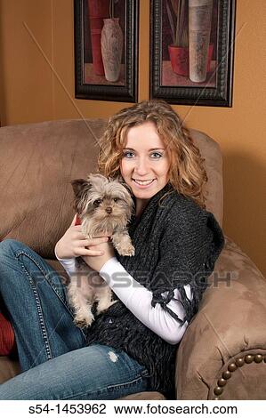 A young woman holding a maltese chihuahua dog indoors View Large Photo Image Stock Image - A young woman holding a maltese chihuahua dog indoors. Fotosearch