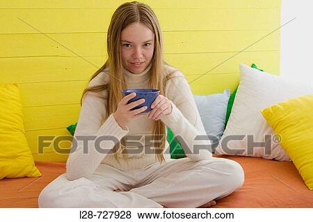 a young woman holding cup View Large Photo Image Stock Photo - a young woman holding cup. Fotosearch