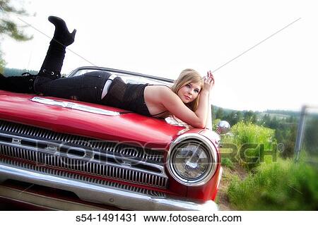 A young woman in 1980s makeup with a red 1964 Dodge Dart. View Large Photo Image Stock Image - A young woman in 1980s makeup with a red 1964 Dodge Dart.. Fotosearch