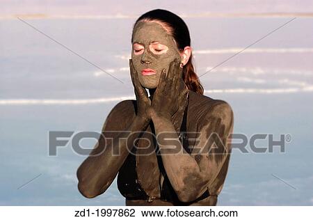 A young woman in a bathing suit is enjoying the natural mineral mud sourced from the dead Sea, Israel. View Large Photo Image Stock Image - A young woman in a bathing suit is enjoying the natural mineral mud sourced from the dead Sea, Israel.. Fotosearch