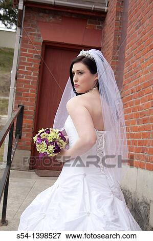 A young woman in a bridal gown near a church in Rosalia, Washington, USA. View Large Photo Image Stock Photo - A young woman in a bridal gown near a church in Rosalia, Washington, USA.. Fotosearch