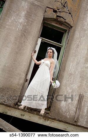 A young woman in a bridal gown, standing by an old building in Rosalia, Washington, USA. View Large Photo Image Stock Photo - A young woman in a bridal gown, standing by an old building in Rosalia, Washington, USA.. Fotosearch