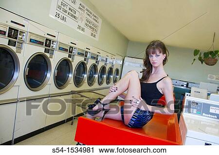 A young woman in a laundromat in Spokane, Washington, USA View Large Photo Image Stock Image - A young woman in a laundromat in Spokane, Washington, USA. Fotosearch