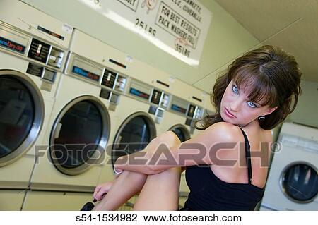 A young woman in a laundromat in Spokane, Washington, USA View Large Photo Image Stock Image - A young woman in a laundromat in Spokane, Washington, USA. Fotosearch