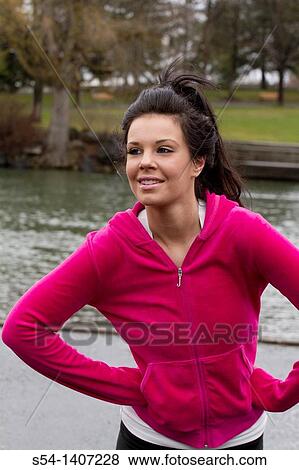 Stock Photo - A young woman in workout clothes at Riverfront Park, Spokane, Washington, USA.. Fotosearch