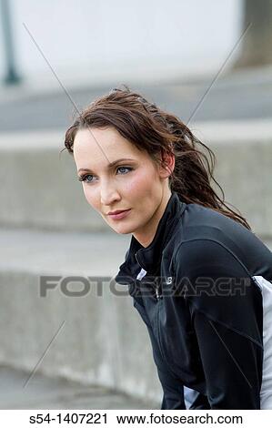 A young woman in workout clothes at the park View Large Photo Image Stock Image - A young woman in workout clothes at the park. Fotosearch
