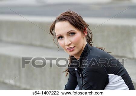 A young woman in workout clothes at the park View Large Photo Image Stock Image - A young woman in workout clothes at the park. Fotosearch