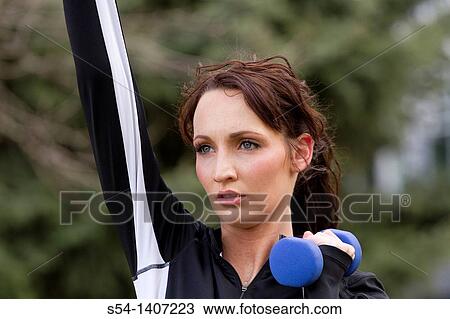 A young woman lifting weights View Large Photo Image Stock Image - A young woman lifting weights. Fotosearch