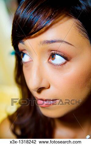 Stock Image - A young woman looking away. Fotosearch