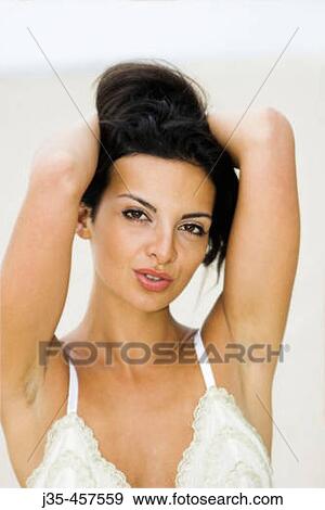 A young woman of 20 something years, holds her arms over head in anticipation. View Large Photo Image Stock Photo - A young woman of 20 something years, holds her arms over head in anticipation.. Fotosearch