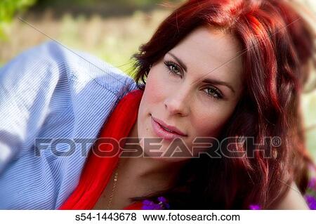 A young woman outdoors in a flower garden View Large Photo Image Stock Photo - A young woman outdoors in a flower garden. Fotosearch