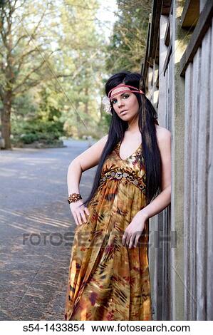 A young woman outdoors in a garden View Large Photo Image Picture - A young woman outdoors in a garden. Fotosearch
