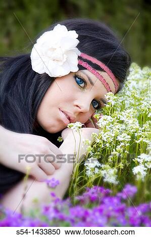A young woman outdoors in a garden View Large Photo Image Stock Image - A young woman outdoors in a garden. Fotosearch