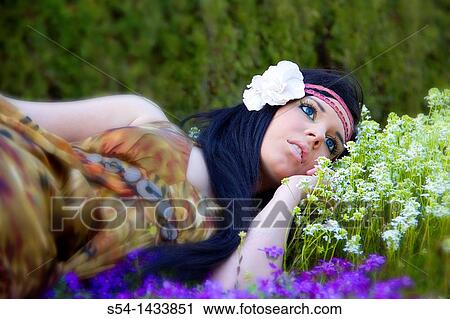 A young woman outdoors in a garden View Large Photo Image Stock Image - A young woman outdoors in a garden. Fotosearch