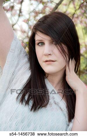 A young woman outdoors in the spring View Large Photo Image Stock Photo - A young woman outdoors in the spring. Fotosearch