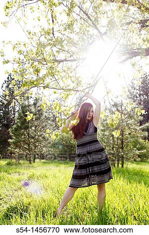A young woman outdoors in the springtime View Large Photo Image Stock Image - A young woman outdoors in the springtime. Fotosearch
