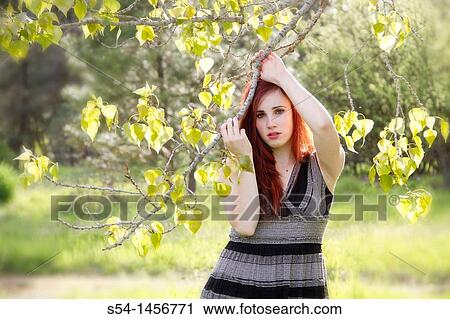 Stock Image - A young woman outdoors in the springtime. Fotosearch