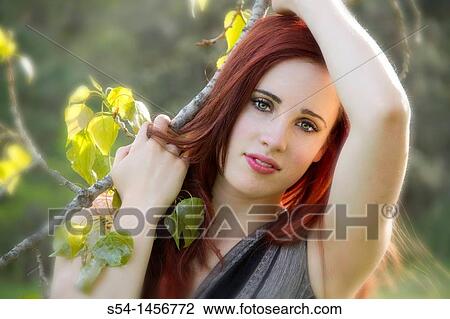 Stock Image - A young woman outdoors in the springtime. Fotosearch