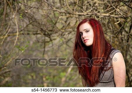 A young woman outdoors in the springtime View Large Photo Image Stock Image - A young woman outdoors in the springtime. Fotosearch