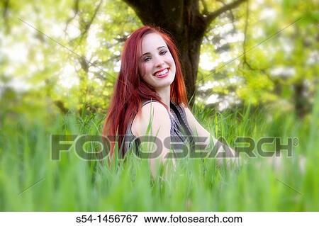 A young woman outdoors in the springtime View Large Photo Image Stock Photo - A young woman outdoors in the springtime. Fotosearch
