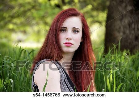 A young woman outdoors in the springtime View Large Photo Image Stock Photograph - A young woman outdoors in the springtime. Fotosearch