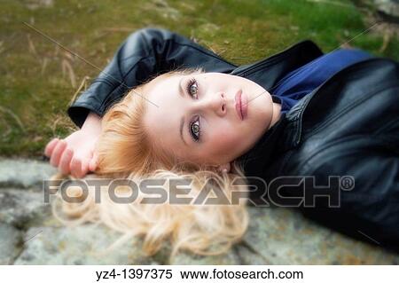 A young woman outdoors, laying on steps View Large Photo Image Stock Photography - A young woman outdoors, laying on steps. Fotosearch