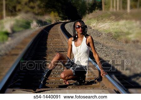 Stock Image - A young woman outdoors. Fotosearch