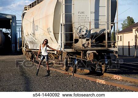 A young woman outdoors View Large Photo Image Stock Image - A young woman outdoors. Fotosearch