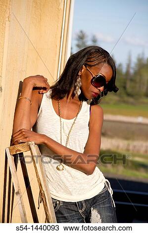 A young woman outdoors View Large Photo Image Stock Image - A young woman outdoors. Fotosearch