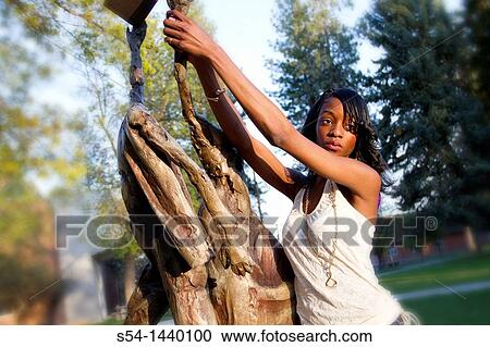 A young woman outdoors View Large Photo Image Stock Image - A young woman outdoors. Fotosearch