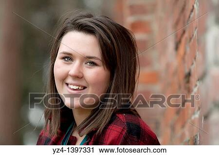 Stock Image - A young woman outdoors. Fotosearch