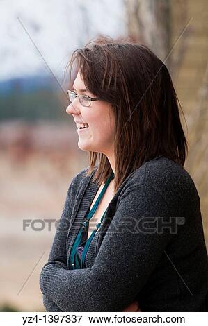 Stock Photo - A young woman outdoors. Fotosearch