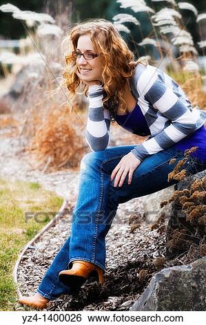 A young woman outdoors View Large Photo Image Stock Photograph - A young woman outdoors. Fotosearch