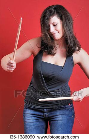 A young woman playing with drumsticks View Large Photo Image Stock Image - A young woman playing with drumsticks. Fotosearch