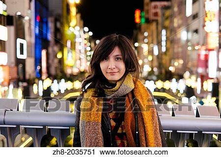 A young woman standing in downtown Osaka, Japan. View Large Photo Image Stock Image - A young woman standing in downtown Osaka, Japan.. Fotosearch